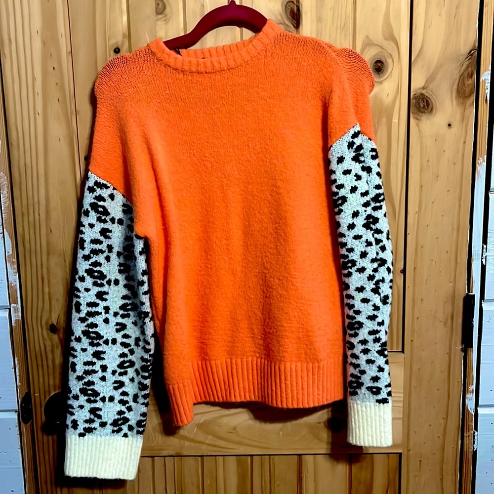 Orange sweater/white sleeves with cheetah print